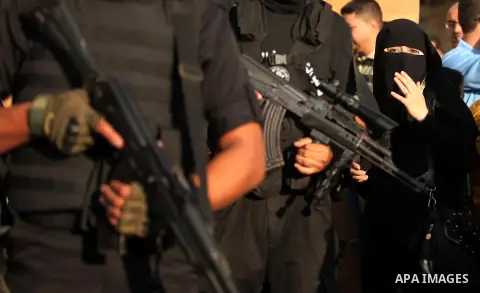Palestinian militants of the Ezzedine al-Qassam Brigades, Hamas' armed wing, take part in a military parade in Gaza city on August 26, 2015. Photo by Ashraf Amra