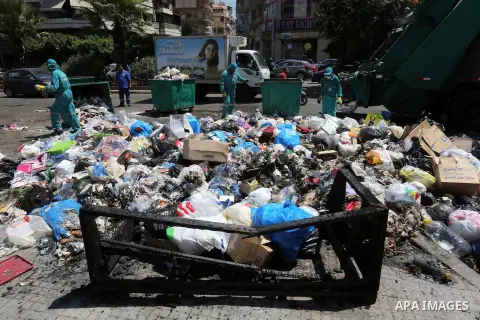 Garbage collectors remove waste from a street in Beirut's eastern suburb of Dora to a temporary location outside of the Lebanese capital on August 27, 2015. A trash crisis began in Lebanon after the government failed to...