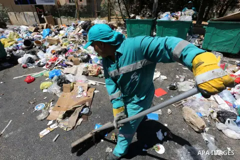 Garbage collectors remove waste from a street in Beirut's eastern suburb of Dora to a temporary location outside of the Lebanese capital on August 27, 2015. A trash crisis began in Lebanon after the government failed to...