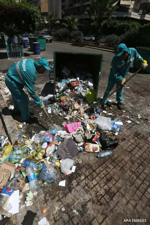 Garbage collectors remove waste from a street in Beirut's eastern suburb of Dora to a temporary location outside of the Lebanese capital on August 27, 2015. A trash crisis began in Lebanon after the government failed to...