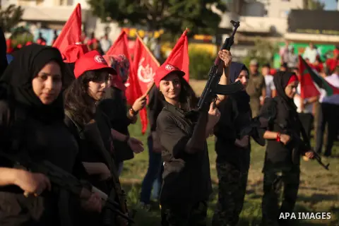 Palestinian girls participate in a military graduation ceremony of the Popular Front for the Liberation of Palestine (PFLP), in Gaza city on August 29, 2015. Photo by Ashraf Amra