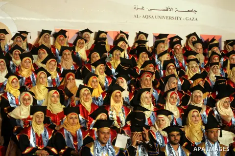 Palestinian students take part in their graduation ceremony at Al-Aqsa University in Khan Younis in the southern of Gaza strip on August 29, 2015. Photo by Abed Rahim Khatib