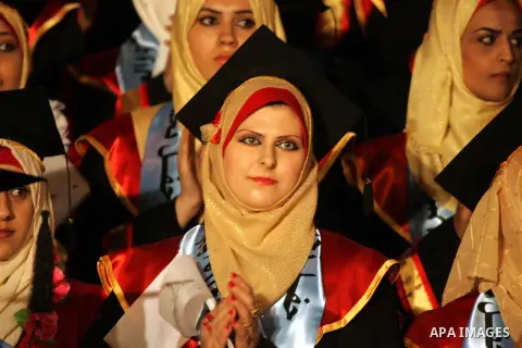 Palestinian students take part in their graduation ceremony at Al-Aqsa University in Khan Younis in the southern of Gaza strip on August 29, 2015. Photo by Abed Rahim Khatib