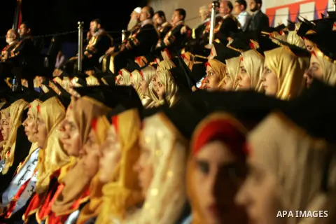Palestinian students take part in their graduation ceremony at Al-Aqsa University in Khan Younis in the southern of Gaza strip on August 29, 2015. Photo by Abed Rahim Khatib