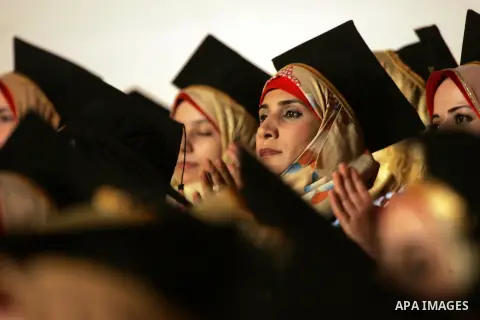 Palestinian students take part in their graduation ceremony at Al-Aqsa University in Khan Younis in the southern of Gaza strip on August 29, 2015. Photo by Abed Rahim Khatib