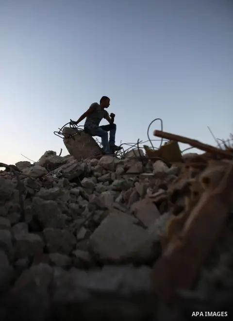 Palestinian men stand on the remains of house after Israeli bulldozers demolished during the Israeli operation, in the West Bank city of Jenin, on Sep. 01, 2015. Palestinian security officials said over 40 Israeli milita...