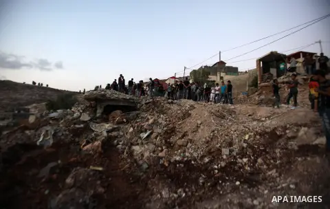 Palestinian men stand on the remains of house after Israeli bulldozers demolished during the Israeli operation, in the West Bank city of Jenin, on Sep. 01, 2015. Palestinian security officials said over 40 Israeli milita...