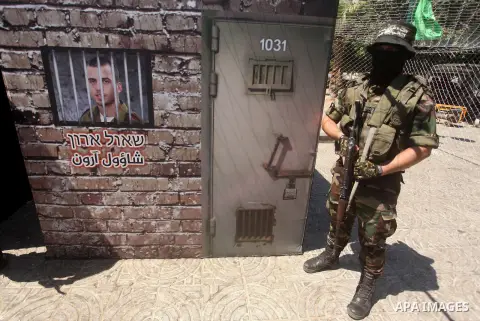 Palestinian militants of the Ezzedine al-Qassam Brigades, Hamas' armed wing, participate in the opening of the exhibition of the al-Qassam mock prisons, in Gaza city, on Sep. 02, 2015. Photo by Ashraf Amra