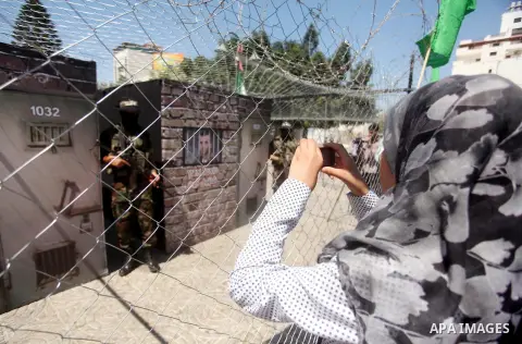 Palestinian militants of the Ezzedine al-Qassam Brigades, Hamas' armed wing, participate in the opening of the exhibition of the al-Qassam mock prisons, in Gaza city, on Sep. 02, 2015. Photo by Ashraf Amra