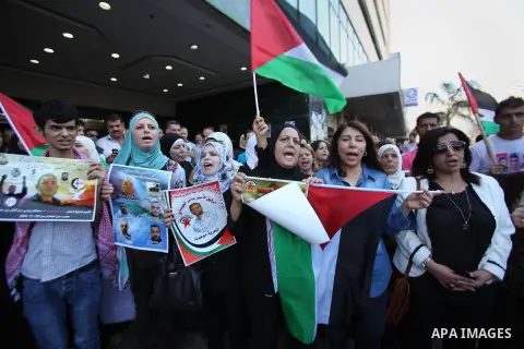 Palestinian protesters hold posters during a protest to show soldarity with prisoners, in the West Bank city of Nablus, on Sep. 03, 2015. Photo by Nedal Eshtayah