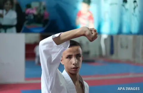 A visually impaired Palestinian boy take parts in a Karate class at al-Masthal club in Gaza city Sep. 06, 2015. The training is held twice a week by the club to lift the morale of the children, trainers said. Photo by As...