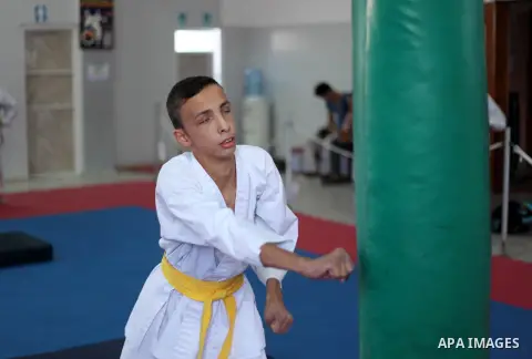 A visually impaired Palestinian boy take parts in a Karate class at al-Masthal club in Gaza city Sep. 06, 2015. The training is held twice a week by the club to lift the morale of the children, trainers said. Photo by As...