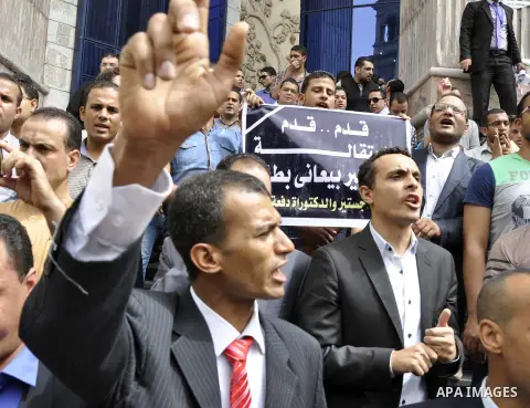 Egyptian teachers and students shout slogans during a protest against the Minister of Education Moheb El-Rafie, and demanding for his dismissal, outside the journalists syndicate, in Cairo on September 10, 2015. Photo by...