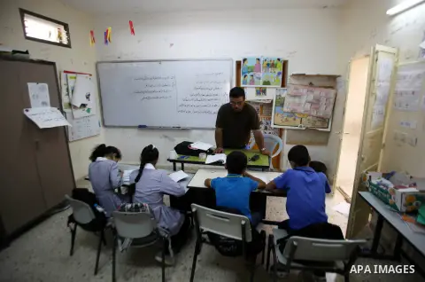 A Palestinian teacher gives a class in Yanun school at the Yanun village southeast of Nablus in the northern West Bank on Sep. 15, 2015. The area of the school which was built in 1970 is seven students study alongside a...