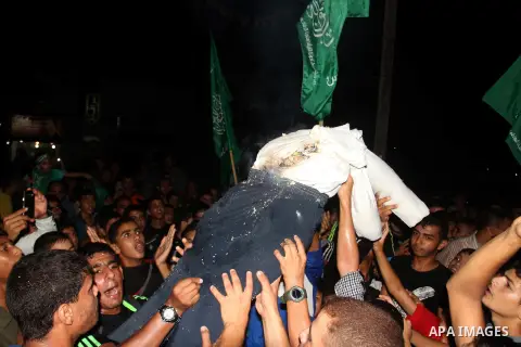 Palestinian supporters of Hamas movement take part in a protest against an Israeli police raid on Jerusalem's al-Aqsa mosque, and against the Palestinian President Mahmoud Abbas in the southern Gaza Strip City of Rafah,...