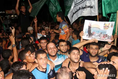 Palestinian supporters of Hamas movement take part in a protest against an Israeli police raid on Jerusalem's al-Aqsa mosque, and against the Palestinian President Mahmoud Abbas in the southern Gaza Strip City of Rafah,...