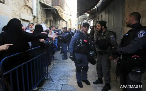 Palestinian activists of the Murabitat group, a movement of Muslim women, shout slogans towards Jews that pray surrounded by Israeli Border Police in alleys lead to the Al-Aqsa mosque compound in the old city of Jerusale...