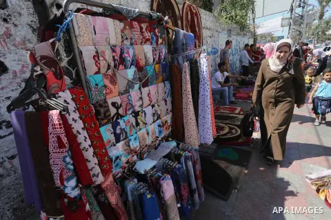 Palestinians shop in a market ahead of the major Muslim festival of Eid al-Adha holiday, in Gaza city, on Sept. 20, 2015. Eid al-Adha, or Feast of Sacrifice, commemorates what Muslims believe was Prophet Abraham's willin...