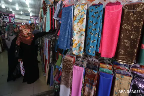 Palestinians shop in a market ahead of the major Muslim festival of Eid al-Adha holiday, in Gaza city, on Sept. 20, 2015. Eid al-Adha, or Feast of Sacrifice, commemorates what Muslims believe was Prophet Abraham's willin...