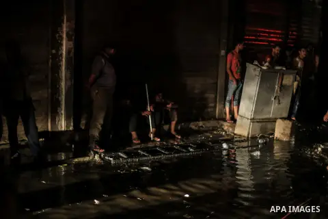 Egyptian firefighters inspect the damage following a fire broke out in al-Gamaliya district, in Cairo on September 20, 2015. At least 4 persons were injured as a number of stores and shops caught fire today, morning, in...