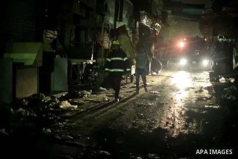 Egyptian firefighters inspect the damage following a fire broke out in al-Gamaliya district, in Cairo on September 20, 2015. At least 4 persons were injured as a number of stores and shops caught fire today, morning, in...