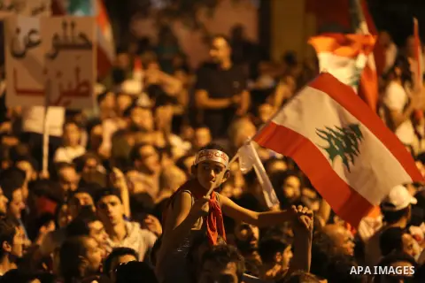 Protesters chant slogans and raise Lebanese national flags during a protest against perceived government failures, including a rubbish disposal crisis, in downtown Beirut, Lebanon September 20, 2015. Photo by Marwan Taht...