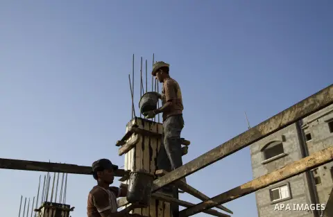 Palestinian construction workers work at the houses, which were destroyed during the 50-day Israeli war in the summer of 2014 in Gaza city on September 20, 2015. Photo by Abdallah Jadallah