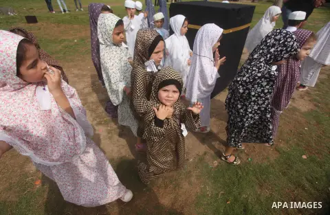 Palestinian children gather around a makeshift cube representing the holy Kaaba in Gaza city, on Sept. 21, 2015, as part of training children how to perform Hajj pilgrimage. Muslims from around the world flood Saudi city...
