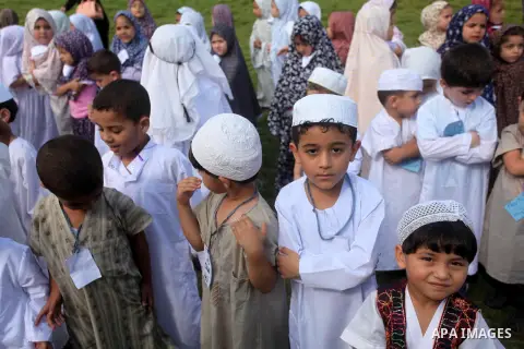 Palestinian children gather around a makeshift cube representing the holy Kaaba in Gaza city, on Sept. 21, 2015, as part of training children how to perform Hajj pilgrimage. Muslims from around the world flood Saudi city...