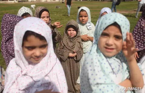 Palestinian children gather around a makeshift cube representing the holy Kaaba in Gaza city, on Sept. 21, 2015, as part of training children how to perform Hajj pilgrimage. Muslims from around the world flood Saudi city...