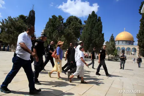 Jewish settlers walk with Israeli policemen at in front of the Dome of the Rock mosque at the al-Aqsa mosque compoun, in Jerusalem old city on September 21, 2015. Israeli police said 39 Palestinians were arrested in the...