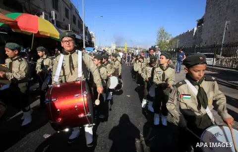 Palestinian scouts play musical instruments as they parade through the streets, celebrating the upcoming Eid al-Adha festival, in Jerusalem old city on September 21, 2015. Muslims across the world are preparing to celebr...