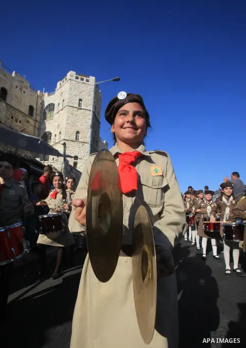 Palestinian scouts play musical instruments as they parade through the streets, celebrating the upcoming Eid al-Adha festival, in Jerusalem old city on September 21, 2015. Muslims across the world are preparing to celebr...