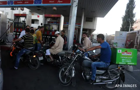 Palestinian drivers wait in line to fill their cars in front of a filling station in Gaza City, on September 21, 2015. Due to severe fuel shortages, the Gaza power plant has been operating at approximately half of its ca...
