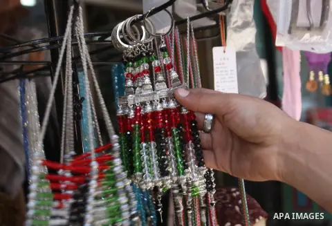 Palestinians shop in a market ahead of the major Muslim festival of Eid al-Adha holiday, in the West Bank city of Nablus, on Sept. 22, 2015. Eid al-Adha, or Feast of Sacrifice, commemorates what Muslims believe was Proph...