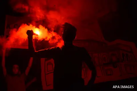 Members of the Egyptian Ultras Nahdawi youth group light flares during a protest against the current Egyptian regime and against the Israeli restrictions at Jerusalem's flash-point Al-Aqsa mosque compound, in Kerdasa nei...