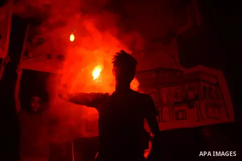 Members of the Egyptian Ultras Nahdawi youth group light flares during a protest against the current Egyptian regime and against the Israeli restrictions at Jerusalem's flash-point Al-Aqsa mosque compound, in Kerdasa nei...