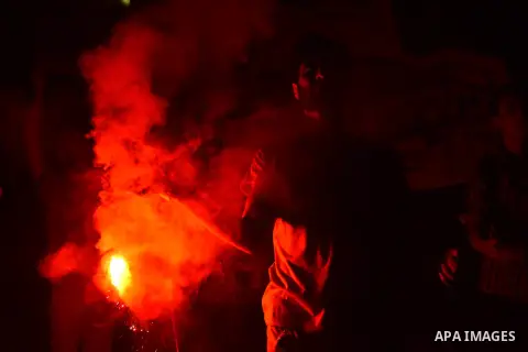 Members of the Egyptian Ultras Nahdawi youth group light flares during a protest against the current Egyptian regime and against the Israeli restrictions at Jerusalem's flash-point Al-Aqsa mosque compound, in Kerdasa nei...