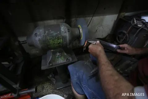 A Palestinian man sharpen knives at his workshop in Gaza city on Sept. 23, 2015. The knives use to slaughter cattle and sheep for the Muslim holiday of Eid al-Adha or the Feast of Sacrifice, which marks the end of the an...