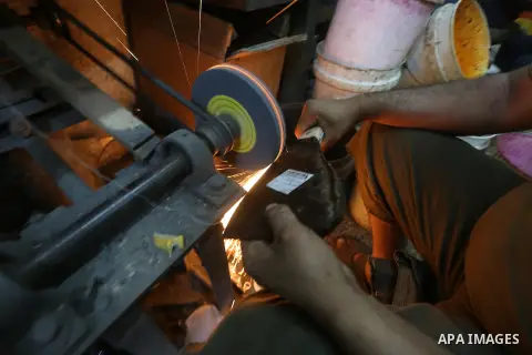 A Palestinian man sharpen knives at his workshop in Gaza city on Sept. 23, 2015. The knives use to slaughter cattle and sheep for the Muslim holiday of Eid al-Adha or the Feast of Sacrifice, which marks the end of the an...