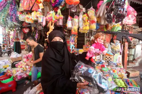 Palestinians shop in a market ahead of the major Muslim festival of Eid al-Adha holiday, in Khan Younis in the southern Gaza strip, on Sept. 23, 2015. Eid al-Adha, or Feast of Sacrifice, commemorates what Muslims believe...