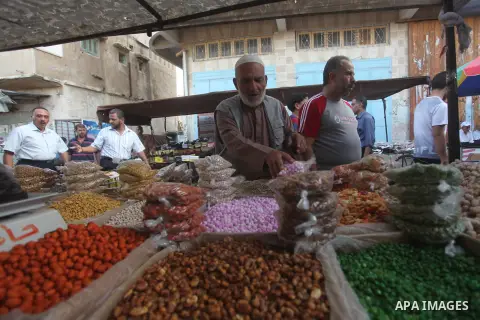 Palestinians shop in a market ahead of the major Muslim festival of Eid al-Adha holiday, in Khan Younis in the southern Gaza strip, on Sept. 23, 2015. Eid al-Adha, or Feast of Sacrifice, commemorates what Muslims believe...