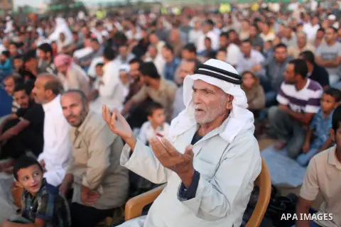 Palestinian muslims pray on the first day of of Eid al-Adha or the feast of sacrifice, in Khan Younis in the southern Gaza Strip on September 24, 2015. Muslims across the world are celebrating the annual festival of Eid...