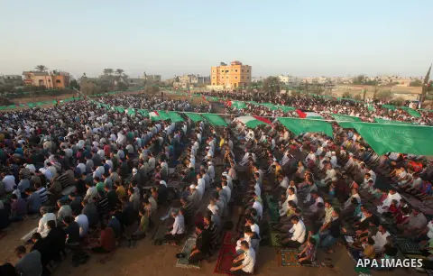 Palestinian muslims pray on the first day of of Eid al-Adha or the feast of sacrifice, in Khan Younis in the southern Gaza Strip on September 24, 2015. Muslims across the world are celebrating the annual festival of Eid...