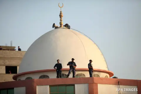 Palestinian security forces stand guard as senior Hamas leader Ismail Haniyeh attends the prayer on the first day of of Eid al-Adha or the feast of sacrifice, in Khan Younis in the southern Gaza Strip on September 24, 20...