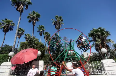 Palestinians play at an amusement park during the fourth day of Eid al-Adha or "Feast of the sacrifice" in Gaza City on September 27, 2015. Muslims across the world are celebrating the annual festival of Eid al-Adha whic...
