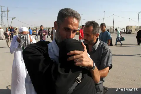 A Palestinian man welcomes his pilgrim relative at the Rafah crossing between Gaza Strip and Egypt after performing the annual Hajj, in Rafah in southern Gaza Strip, September 30, 2015. Around 500 Hajj pilgrims cross Raf...