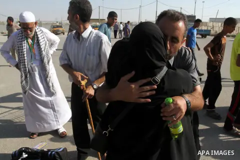 A Palestinian man welcomes his pilgrim relative at the Rafah crossing between Gaza Strip and Egypt after performing the annual Hajj, in Rafah in southern Gaza Strip, September 30, 2015. Around 500 Hajj pilgrims cross Raf...