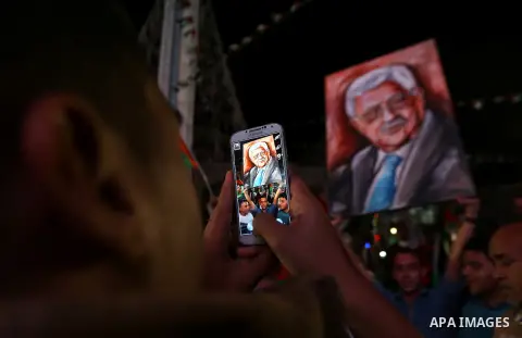 Palestinians celebrate following the Palestinian President Mahmoud Abbas' speech at the General Assembly at the United Nations, in the West Bank city of Ramallah on September 30, 2015. Demonstrating a new level of tensio...