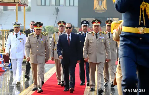 A handout picture released by the Egyptian Presidency shows Egyptian President Abdul Fattah al-Sisi (C), Defense Minister Sedki Sobhi (L) and Chief of Staff Mahmoud Hegazy (R) leaving after their visit to former Egyptian...